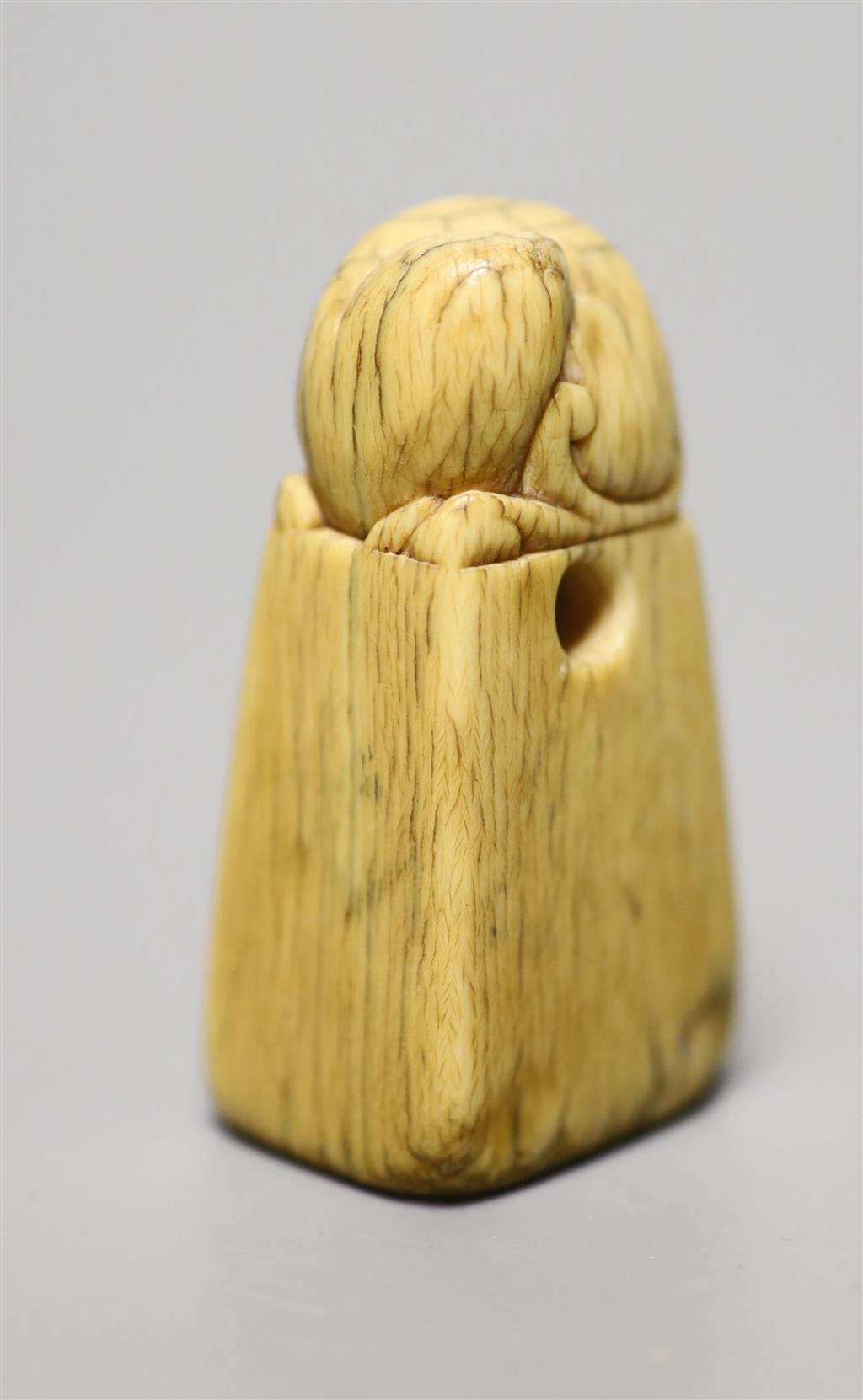 A Chinese Ming ivory seal, height 5cm, carved with a lion-dog